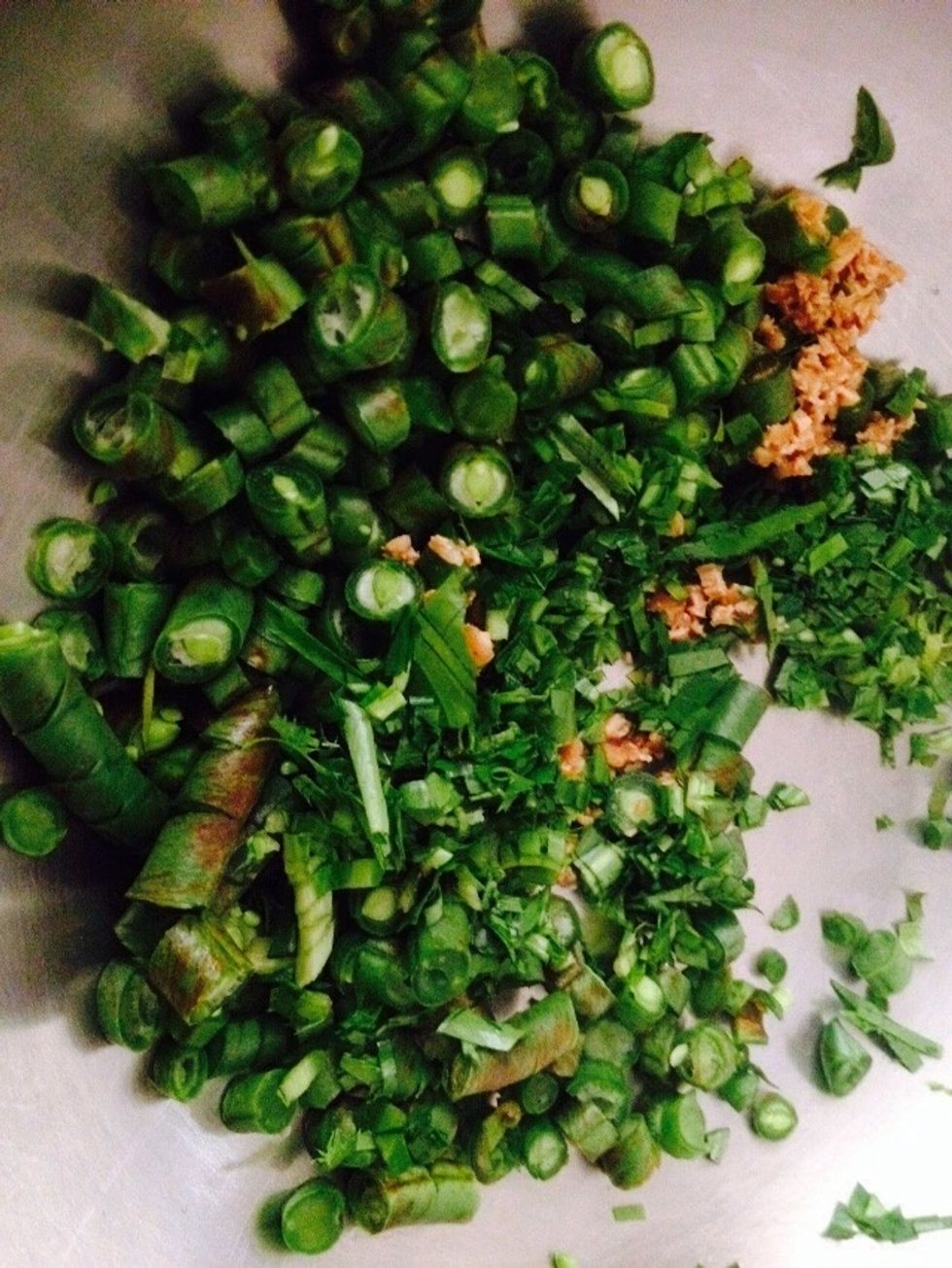 In a clean & Dry bowl - add diced beans, krachai (in the ginger family) & minced coriander & Kaffir Lime leaves.