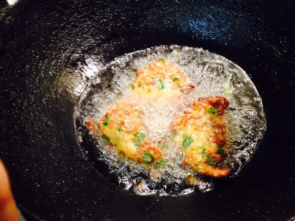 In a hot work - add oil. Fry the fish cakes in batched.