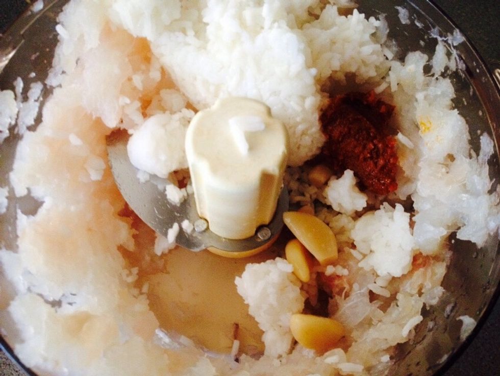 Now add 2 dash of fish sauce, cooked rice, the paste to your taste (tom yum or red curry) & pickled garlic.