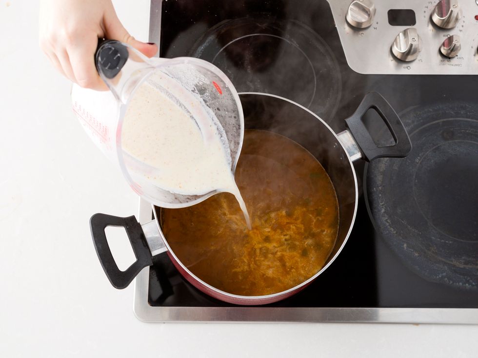 Once the chicken is removed, add a mixture of milk and masa harina.