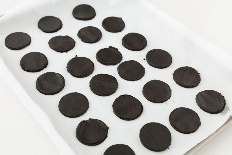 Using a 2-inch round cookie cutter, cut into circles and transfer to a prepared baking sheet.