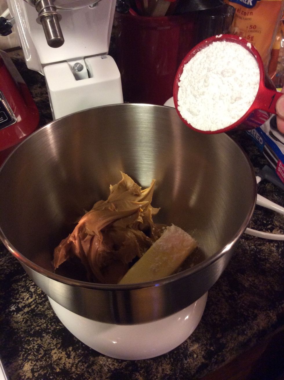 1 1/2 cups creamy peanut butter, 1 cup powdered sugar, and 1 stick (8 tablespoons) softened butter to a large mixing bowl