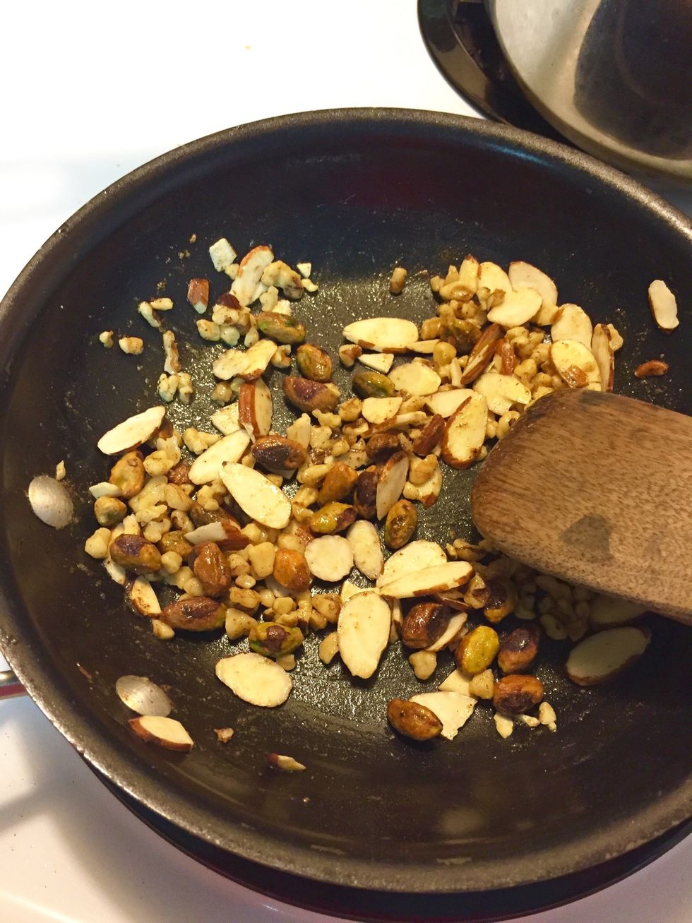 1) add butter, paprika, cayenne and agave to non stick skillet.    2) when butter has melted, add nuts. toast and toss til butter mixture has been absorbed by nuts.   3) set aside to cool.