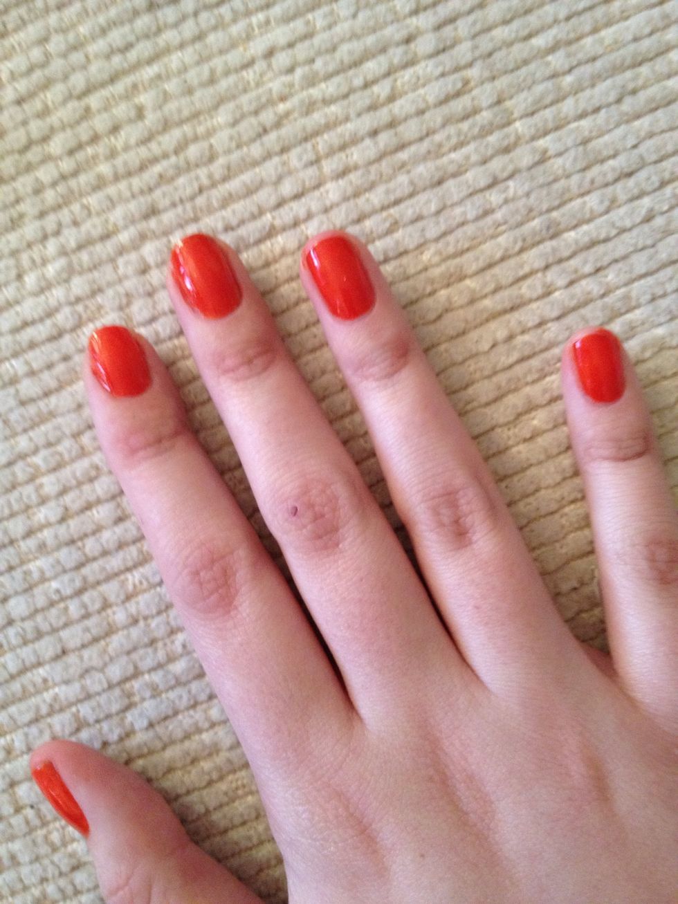 1. Apply base coat, and a further two coats of red nail varnish. Allow drying time between coats. Use 1 end of the cocktail stick wrapped in cotton wool dipped in nail varnish remover to fix mistakes.