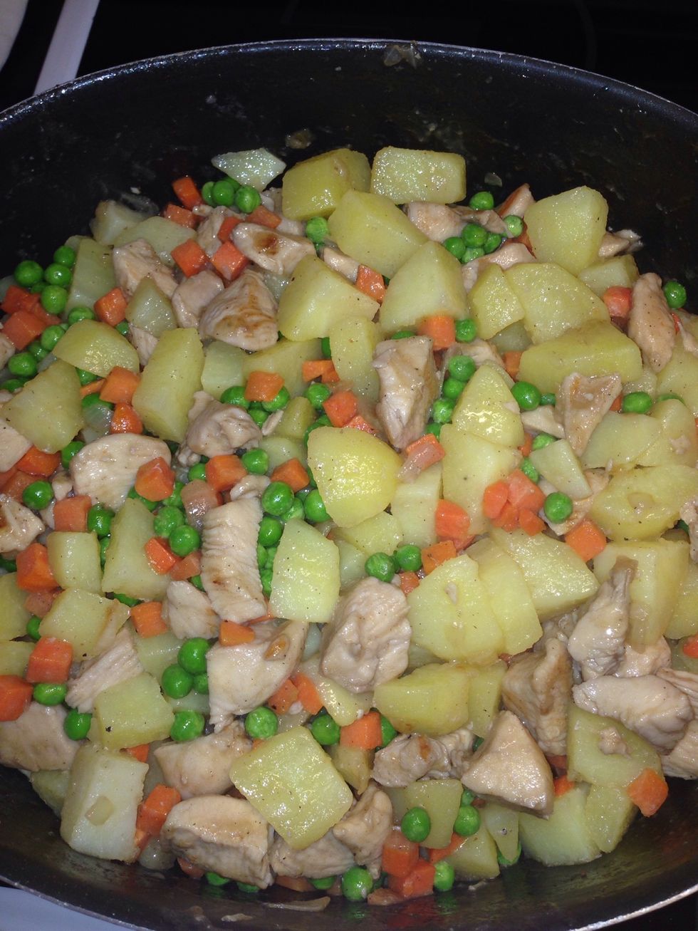 1) boil your potatoes separate 2) fry your chicken file 3) add the frozen peas and carrots 4) season 5)add potatoes when done cooking half way