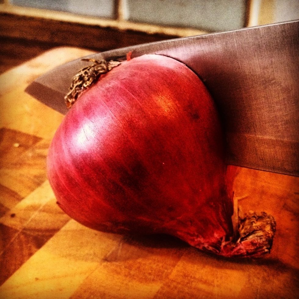 1. Cut onion in half. This method works because you are removing both the tip and base quickly, however some onions are stronger than others so have a bag ready to bin the waste