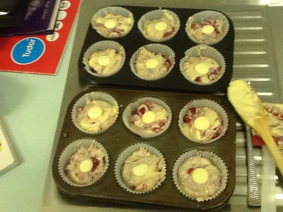 1: Get ahold of some baking trays and spray it with oil. 2: Pour the mixture in and add some chocolate bits on top.