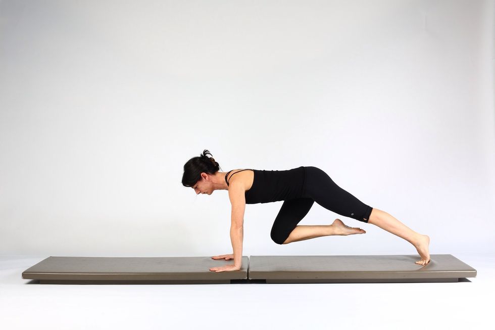 1. KNEE TO CHEST-  Start in high plank. Maintaining shoulder and hip alignment draw one knee towards chest