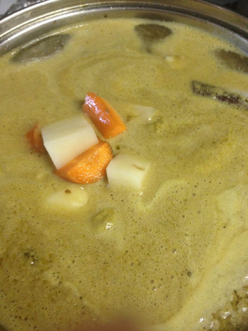 1. Let the mixture boils then put in potatoes and carrot 2. Let it simmer for a while until the potatoes are cooked 3. Put in a little bit of pepper