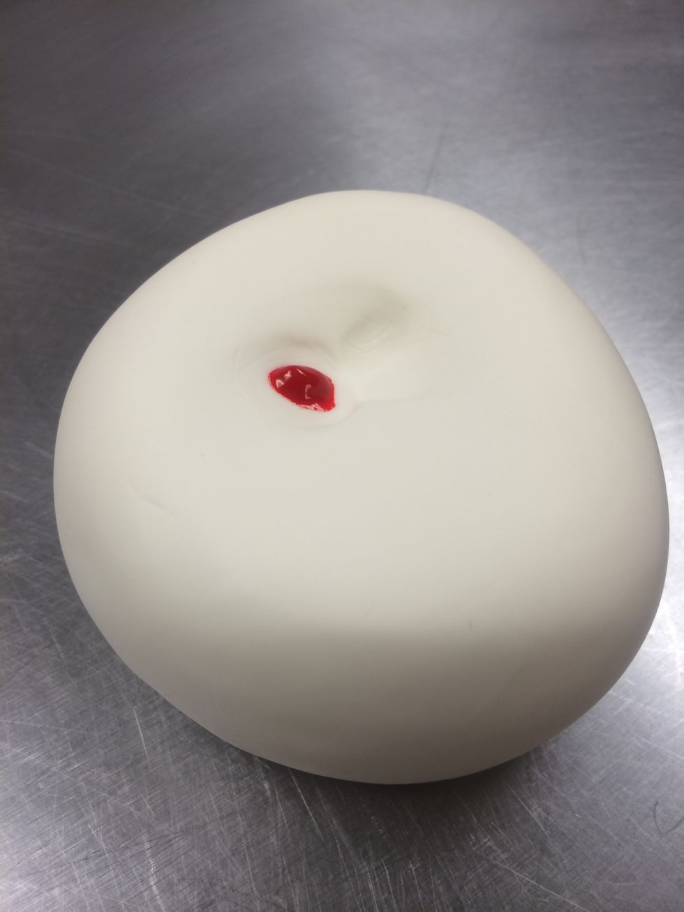 1 or 2 drops of coloring will be enough to color this piece of fondant. Kneed the coloring in with both hands, work the fondant on a surface dusted lightly with powdered sugar to prevent sticking.