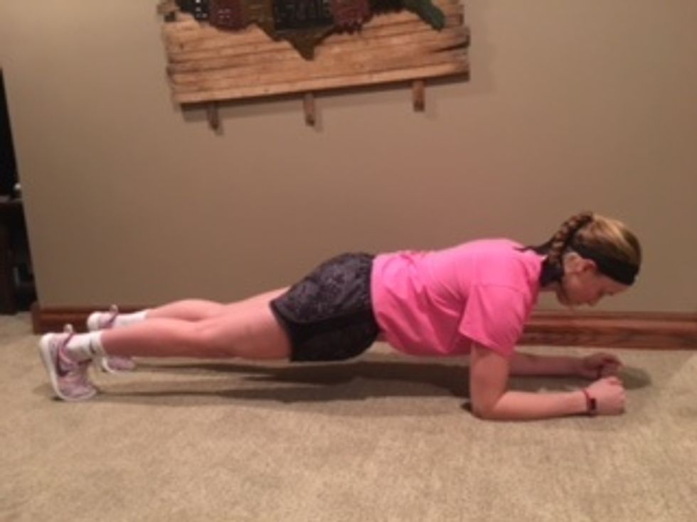 1. Plank- Press your forearms on the ground with your legs extended behind you. Lift your body. Keep your chin behind your hands. Shoulders, back, and hips should be in-line. Hold for 30 seconds.