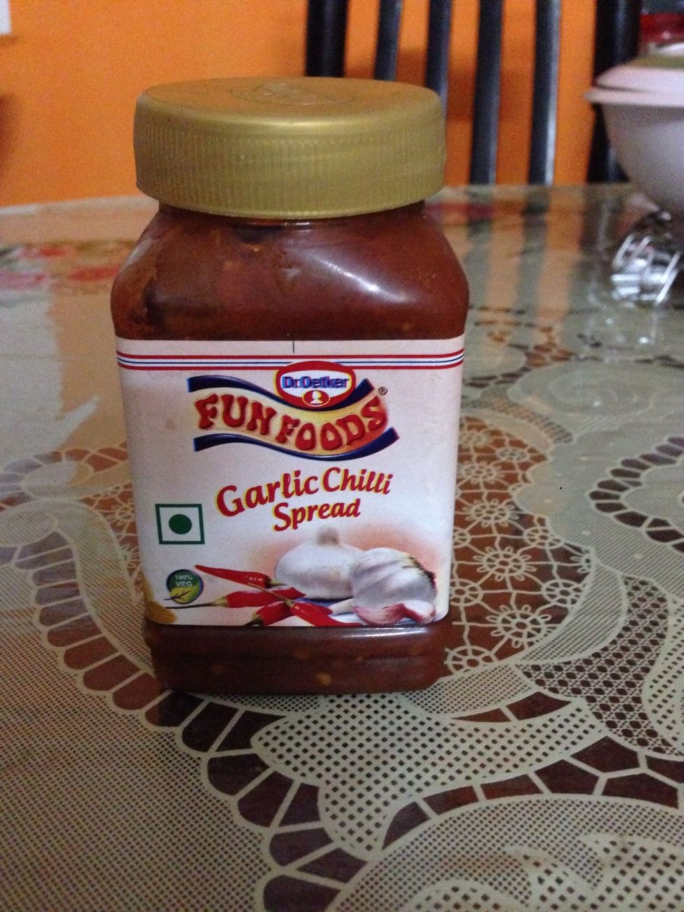 1. Take bread . 2. Take pizza spread and spread it on the bread