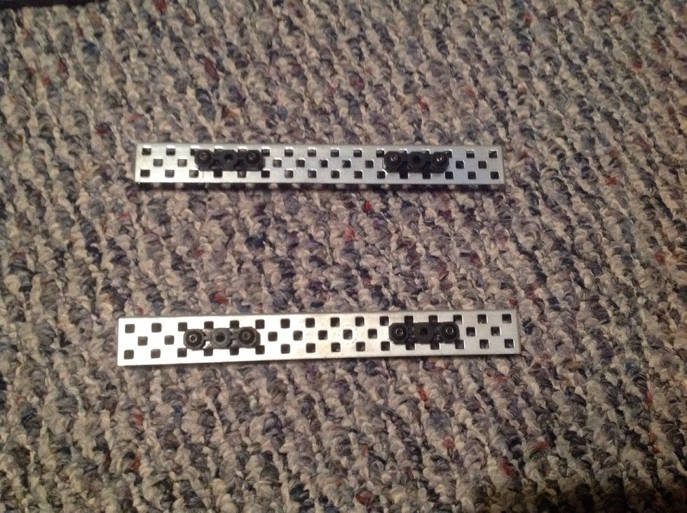 1. Take two Chassis Rails and four Offset Pieces; place the Offset Pieces on the Rails as shown on the picture. Then, fasten the Offset Pieces with 8 Keps Nuts and 8, 8-32 1/2" Screws