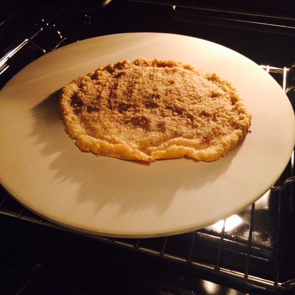 1.Using a pizza stone: put crust on the pre-heated plate. (read instructions for your plate). Other/pan: put crust on the pan w/brown paper \n2. Heat(both sides) until golden. Turn after 10-15 mins.