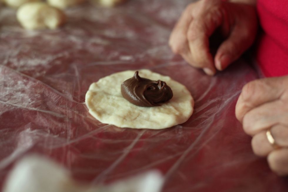1 very heaped tablespoon of the chocolate ganache mixture in the centre of the dough. Put the dough in the palm of your hands and close the dough.. Nothing should be overflowing or messy.