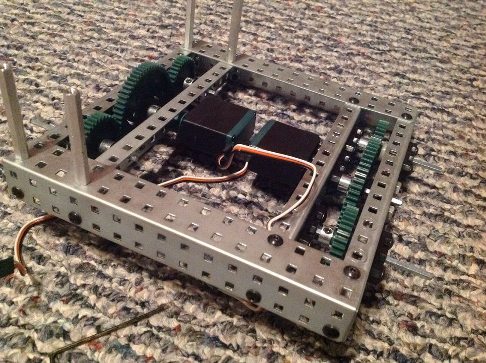 11. Use 4 8-32 1/4" Screws and 4 Keps Nuts to further secure the chassis to Chassis Bumpers where shown. Also, insert the Wheel Hubs into the Rubber Wheel Covers.