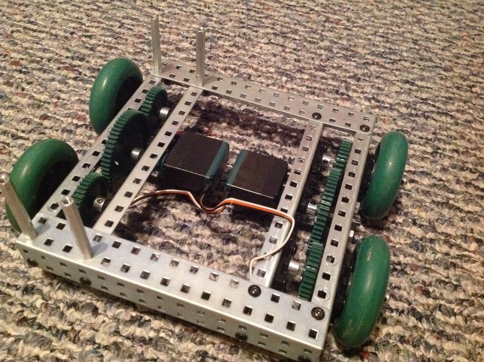 12. Slide the Finished Wheels over all four left and right Square Rods. Take 4 Metal Collars and slide on all four left and right Square Rods. Secure once against wheels.