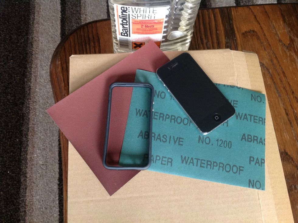 1200 grade sandpaper or higher, this is very very fine. If you go to a lower grade you may scratch up your phone even more. It's a good idea to have screen protectors on before you start.