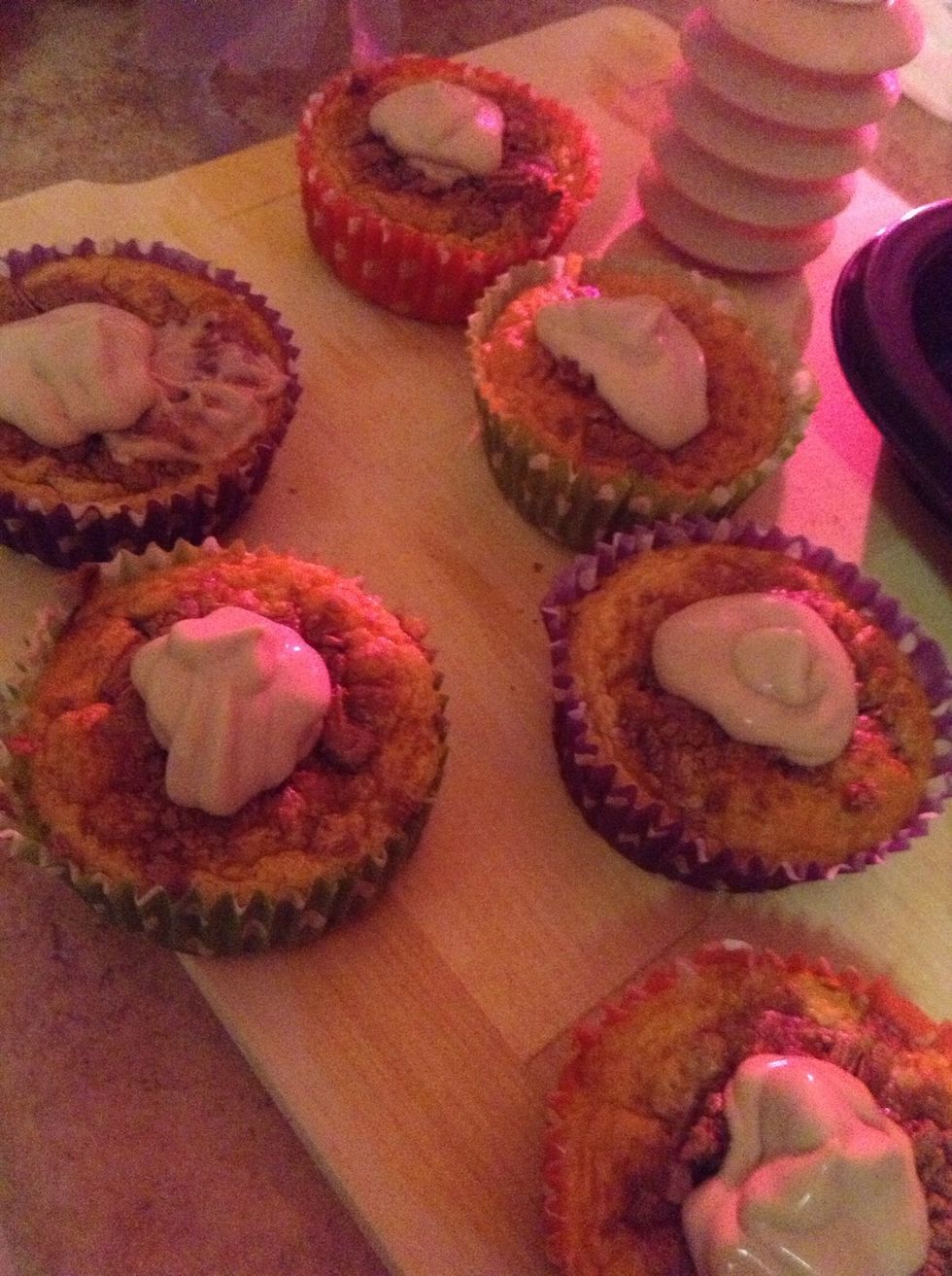 14.) Get an icing piper and fill it with your newly mixed icing. Then fill in the holes on the cupcake with the chocolate icing to create a bauble like shape on top of the cupcake