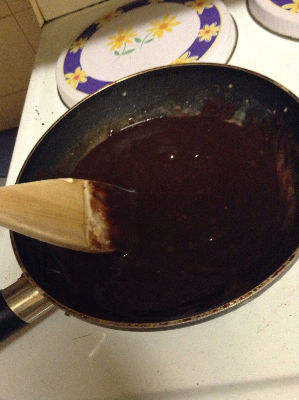14.) Once the cake is fully cooled, put the cream in a small saucepan, and bring it to a simmer. Once simmering, remove from the heat and add your chopped chocolate. Leave the heat on though, and stir