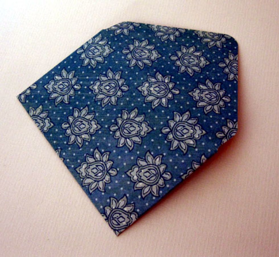 14.\tCreate a 3 1/2\u201d x 2 1/4" envelope to hold a gift card. If using the We R Memory Keepers Envelope Punch Board, cut out a 5\u201d square of decorative paper and score at 3\u201d.