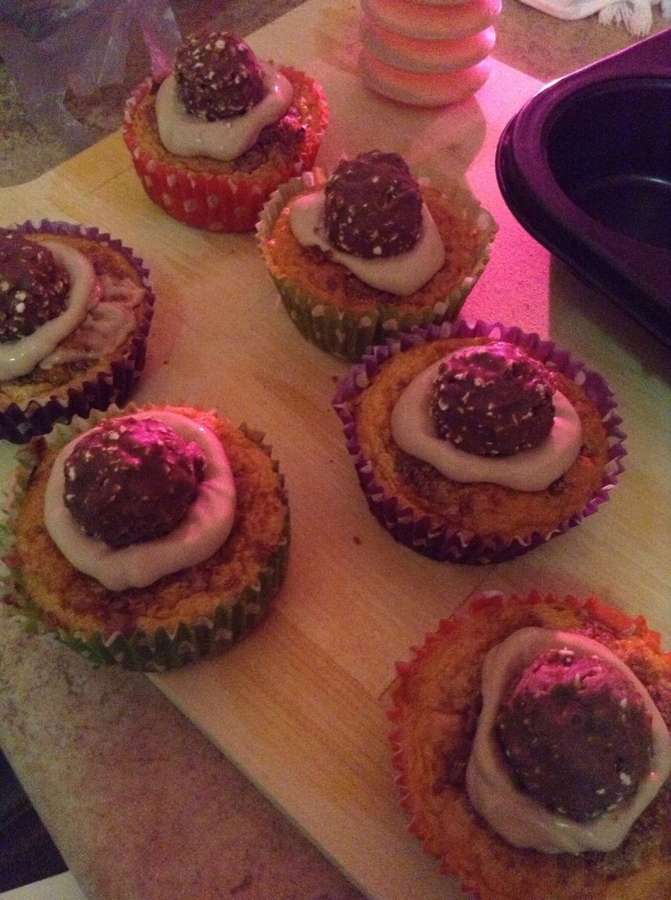 15.) Add your Ferraro Rochers on top of each cupcake, and gently squash them down so the icing expands in size