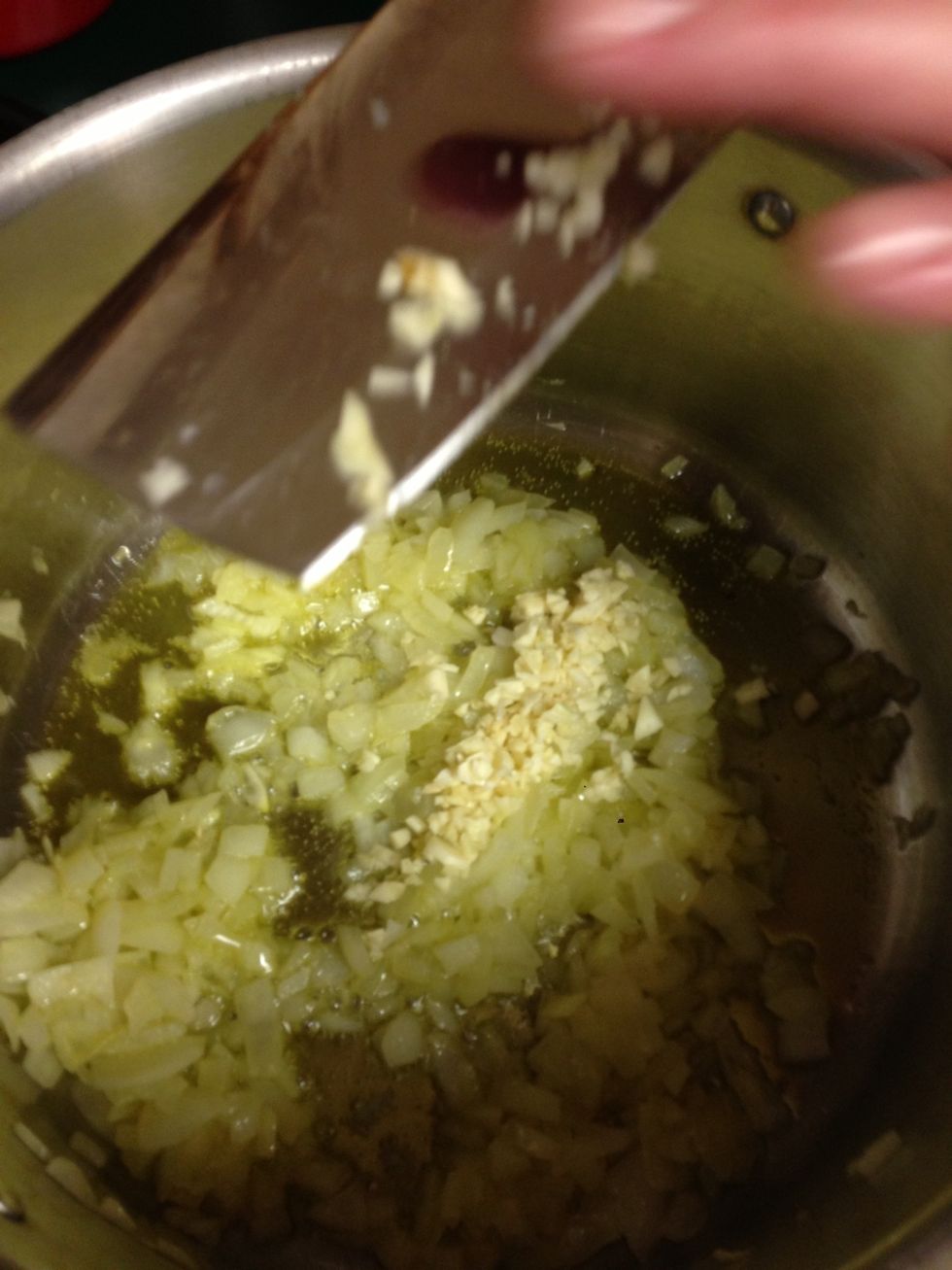 15 minutes, the onions are turning opaque. Time to add diced garlic. Butter also cuts the acidity of the onions.