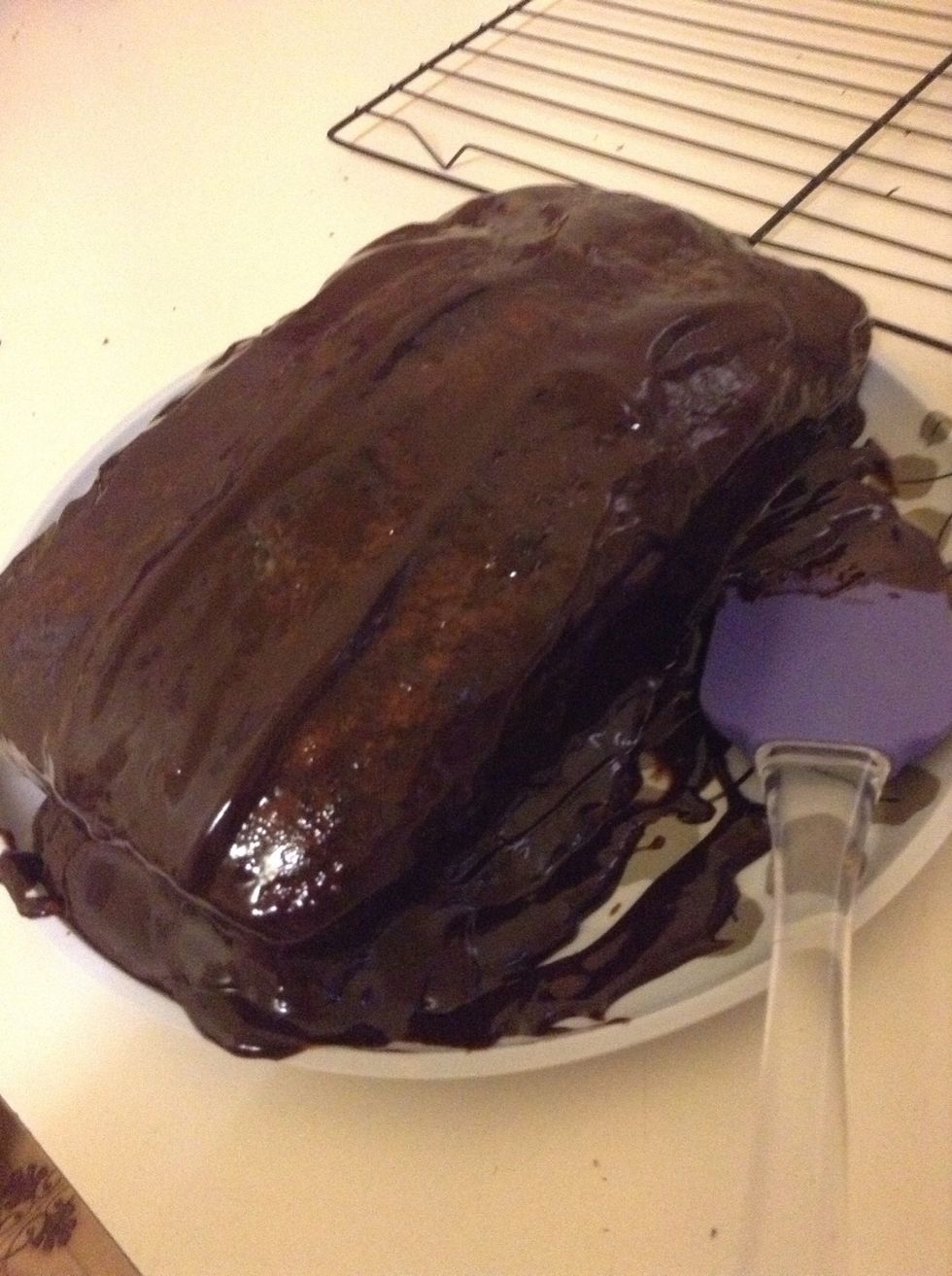 17.) Once the ganache is cooled (as well as the cake itself,) 'plaster' it on top and on the sides of the cake. For me, there was quite a lot of icing left over - so I just ate it....