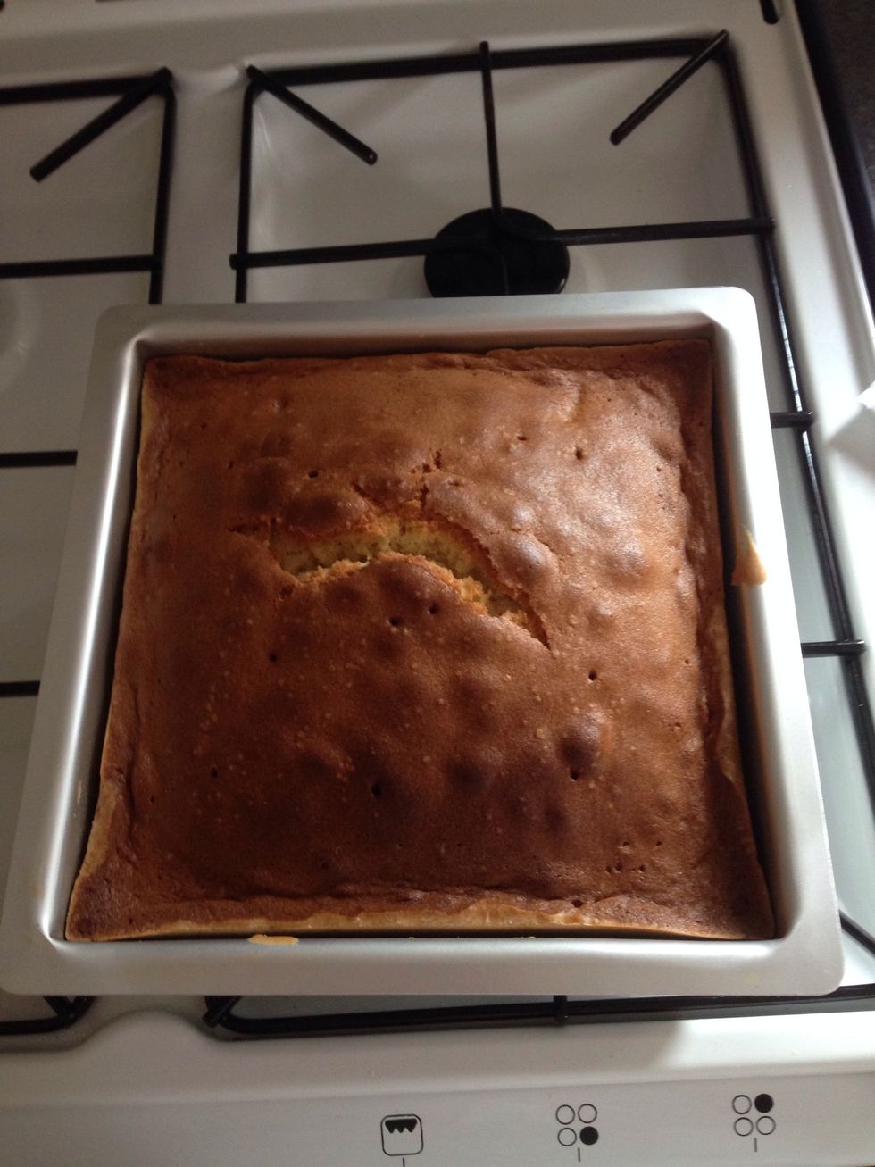 1hr 15mins later, take the cake out of the oven & let cool in tin for about 10 mins or until the tin is cool enough to handle