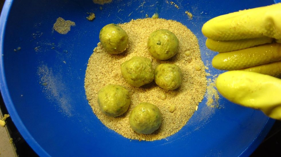 1ST BREADCRUMB COATING - Add 4-5 egg soaked fish balls into the bread crumb bowl and shake from side for about 10 seconds. That will give it a nice even coating of bread crumbs.