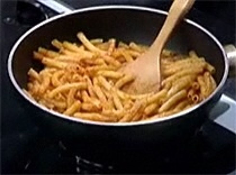 1stly Boil pasta in water untill it gets soft .Add cooking oil. Fry pasta with tomato sauce. Then put it aside.