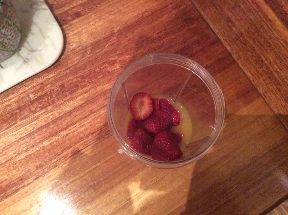 2. Add the strawberries you can either use fresh or frozen strawberries if you use frozen less ice will be needed but if you use fresh strawberries make sure to wash and remove the crown.