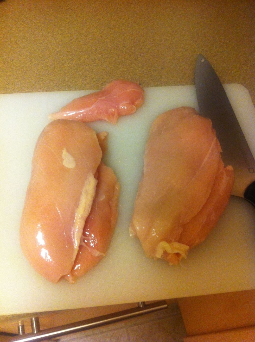 2 chicken breasts on a cutting board. Cut them into tenders