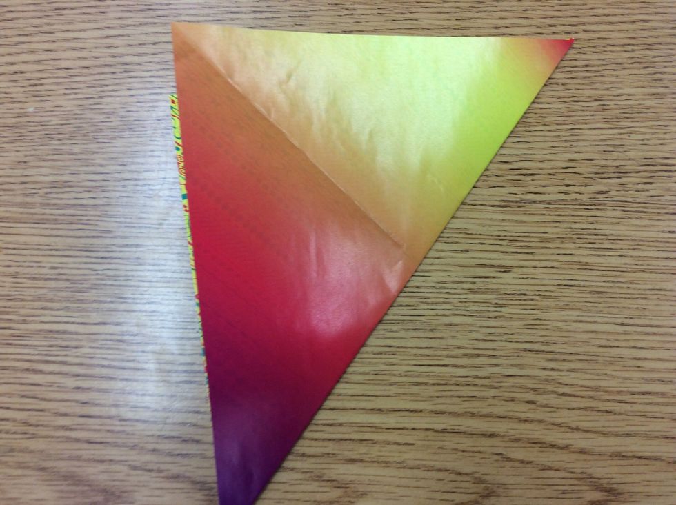 2.Fold one corner to the opposite, then do that on the opposite corners so it forms an "X". Then unfold.