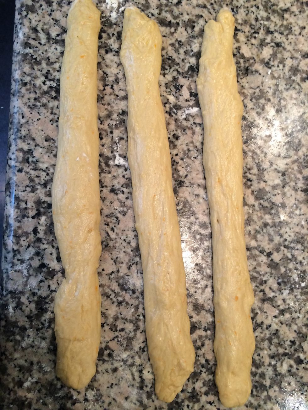 2 hrs after the dough would have tripled in size. Put it on a floured top. Knead for 1 min cut into 3 parts. Make 3 strands and make a braid.