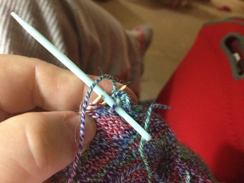 2) Let the 1st stitch on the front needle slip off the knitting needle.