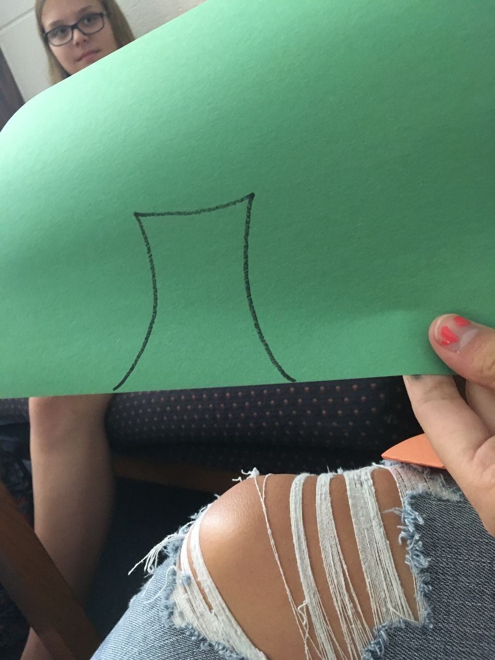 2. Next, cut the shape of the stem on the black line on the green paper.