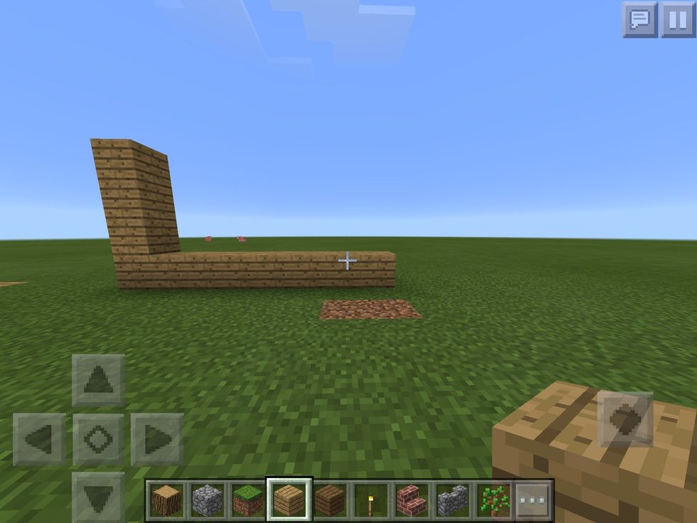 2. Once you have done the first step you place the block on the ground by tapping the disiered place go up by 4 then you go back to the starting place and go across by 7 blocks to the left or the righ