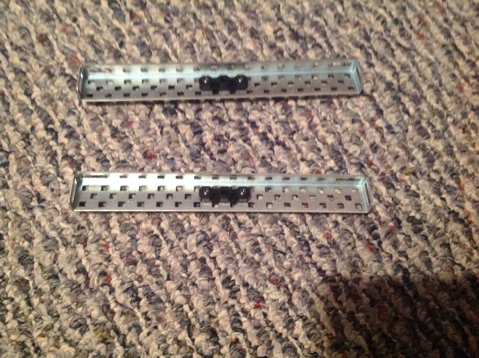 2. Take the other two Chassis Rails and place two Offset Pieces on the inner side of the Rails as shown. Then, fasten them with 4 Keps Nuts and 4, 8-32 1/2" Screws.