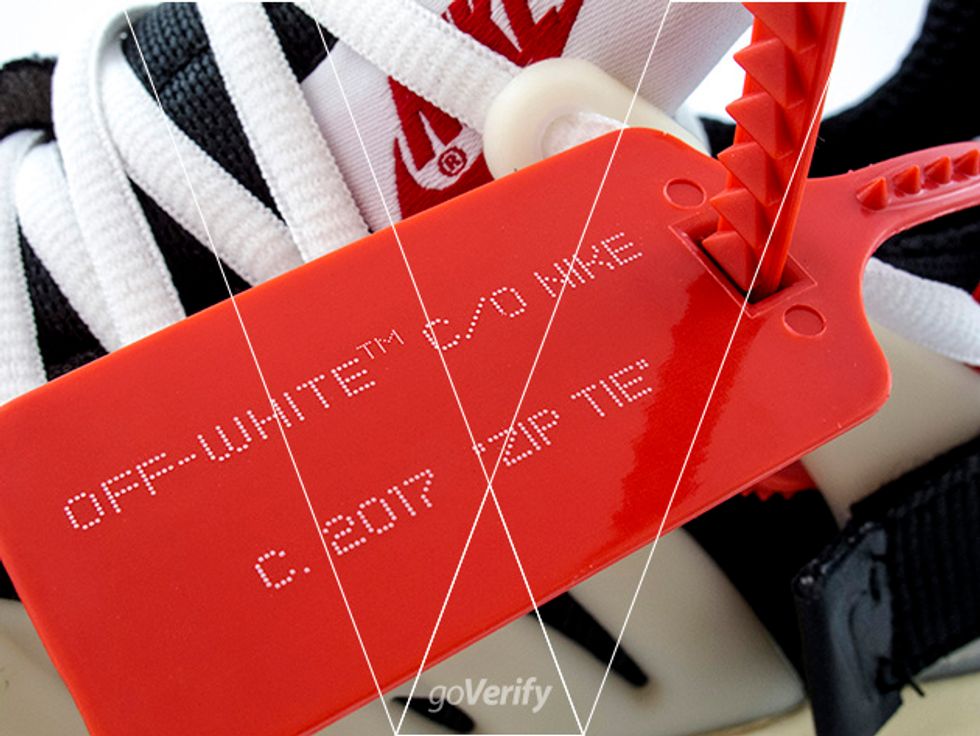 2. The zip tie will have Off-White TM c/o Nike c. 2017 Zip Tie. Make sure the typeface is correct, note how the TM is printed in much smaller white dots.