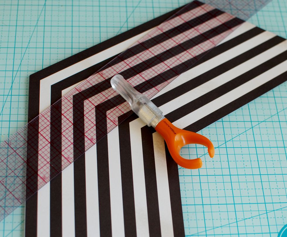 2.\tWith a ruler and knife or paper cutter, follow the lines on the Heirloom Roses Sheet and cut the paper so you have 7 black arrows.