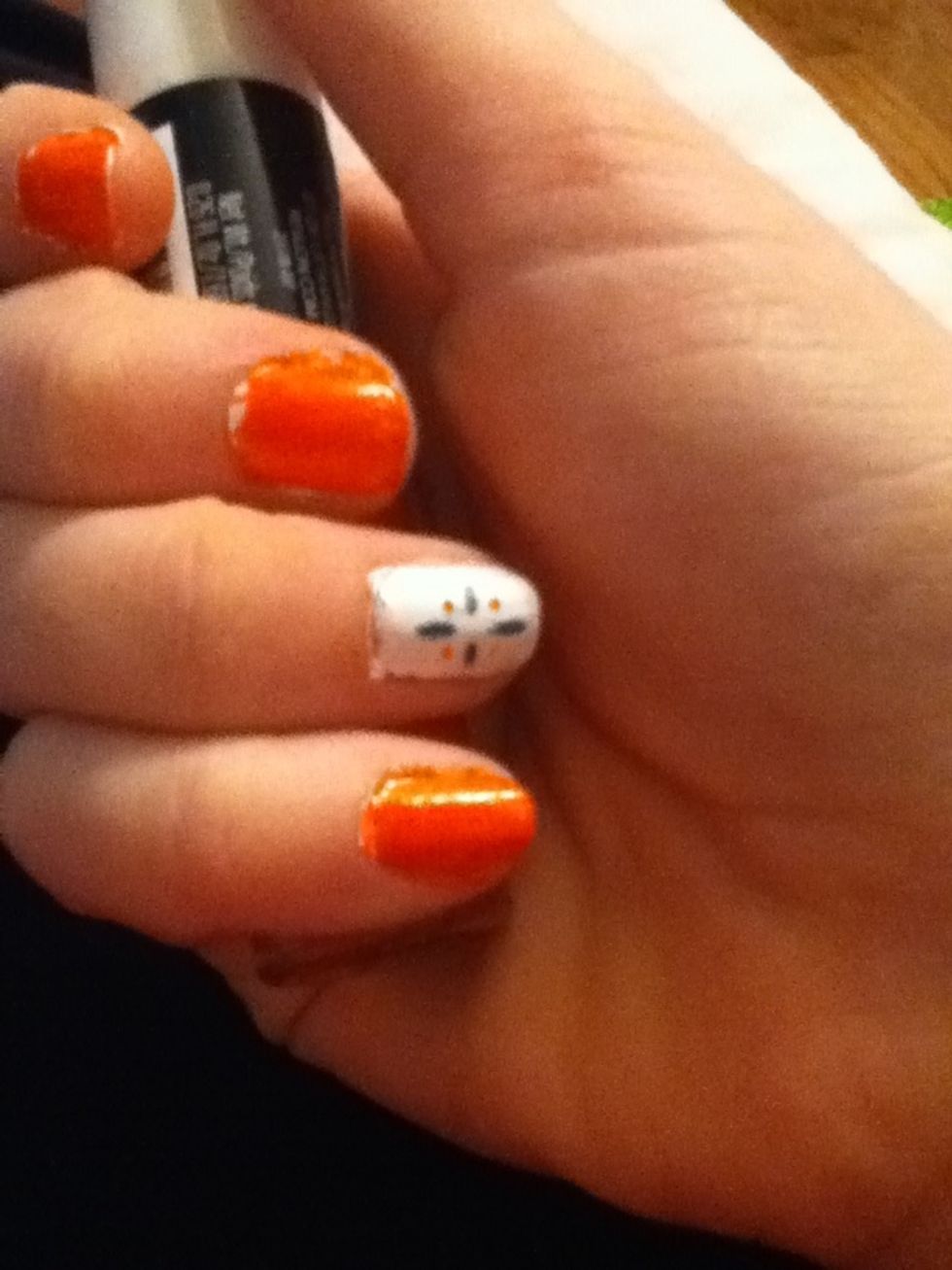 2nd coat. This was my design on my feature nail. I just took a toothpick and drew a line in a blue-ish color and dots in the neon orange color.