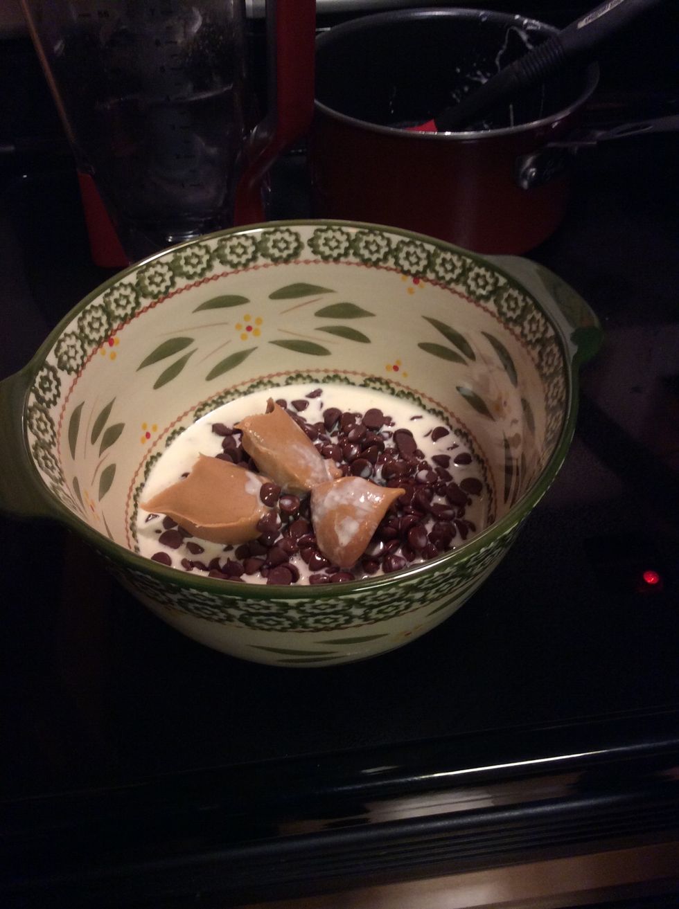 3/4 cup heavy whipping cream being added to chocolate chips and peanut butter then cover, let sit for 5 minutes.