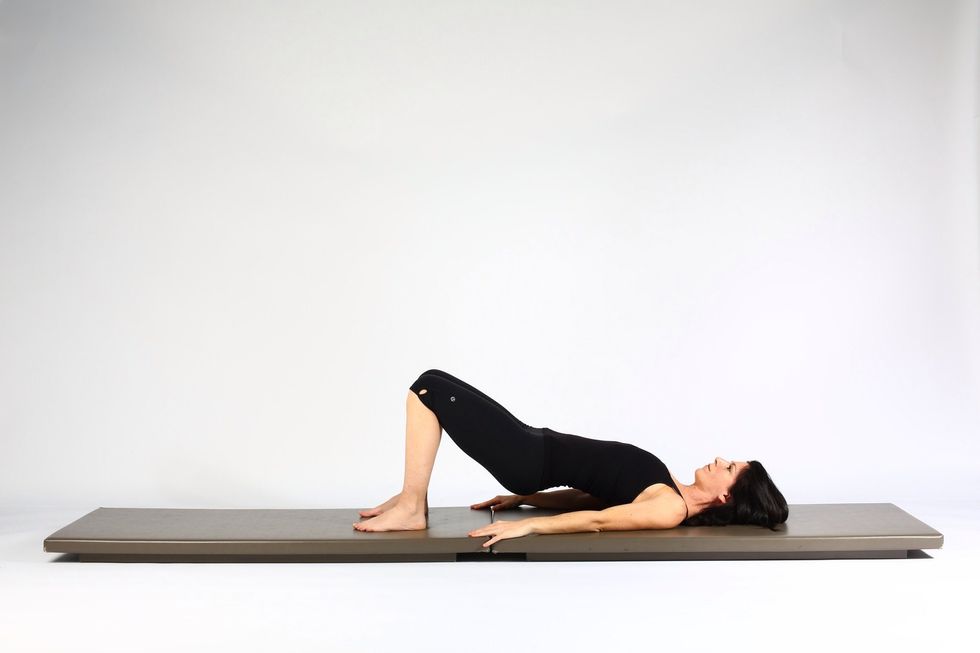 3. HIP LIFT - Lower hips and pelvis half way down to mat. Try to keep the push of the feet as strong on the lowering of the pelvis when as when you are and lifting.