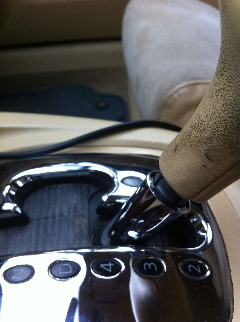 3. Pull down the chrome sleeve under the shifterknob.