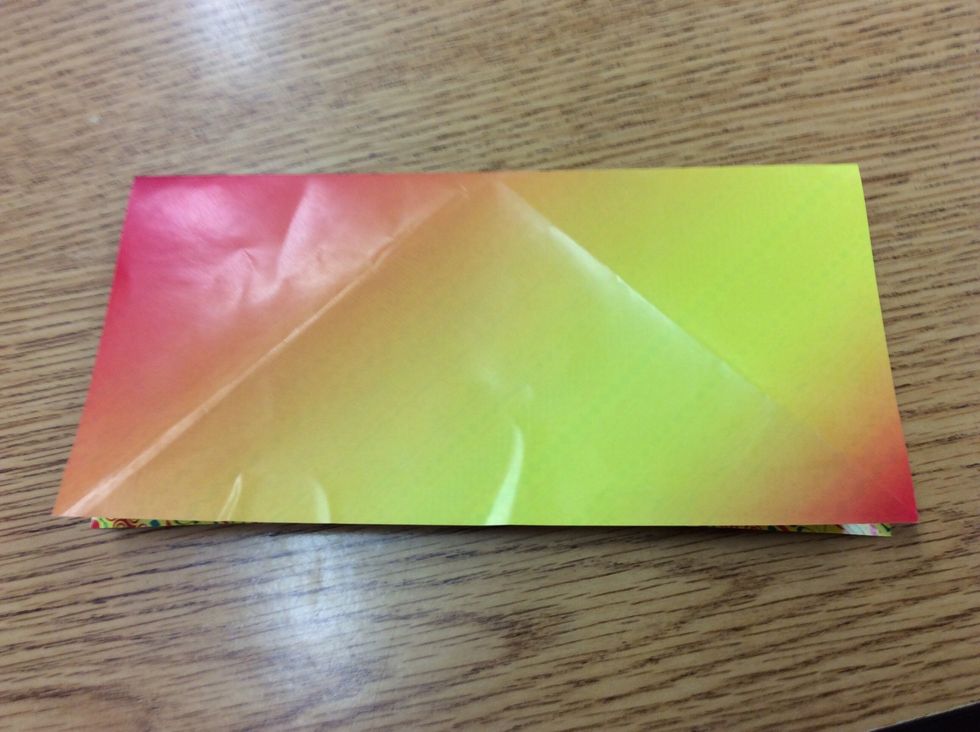 3. Take the top two corner and fold them down, then unfold. Then take the top right and bottom right corner, so you can fold it over to the opposite side. Then unfold.