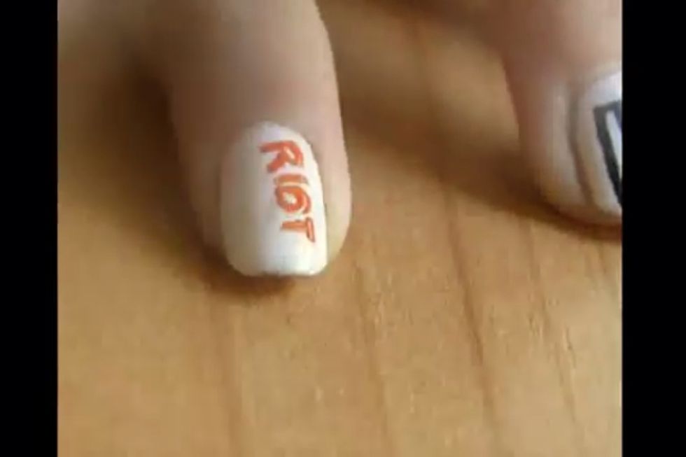 3.) Using the same nail brush, draw 'Riot' in orange.