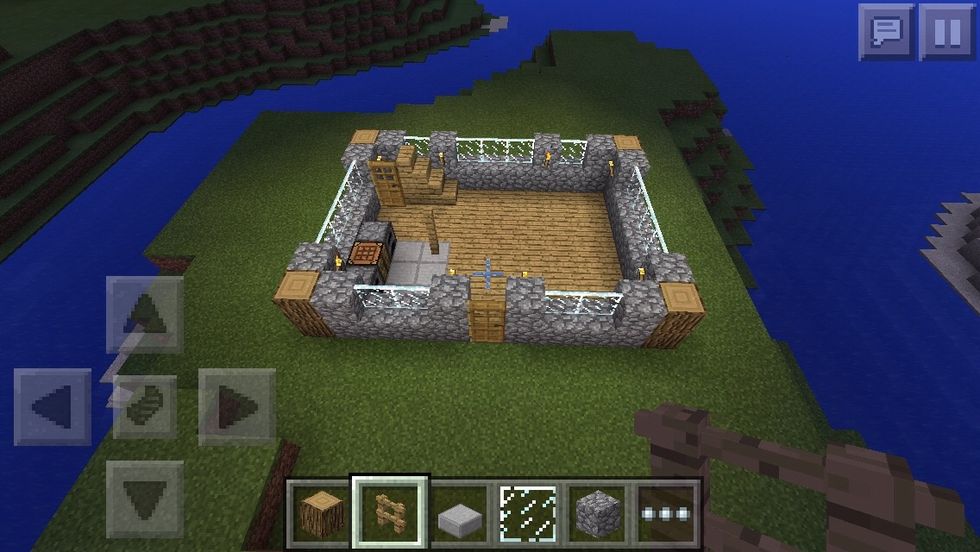 3rd layer continue with the fence post walls and add torches and windows