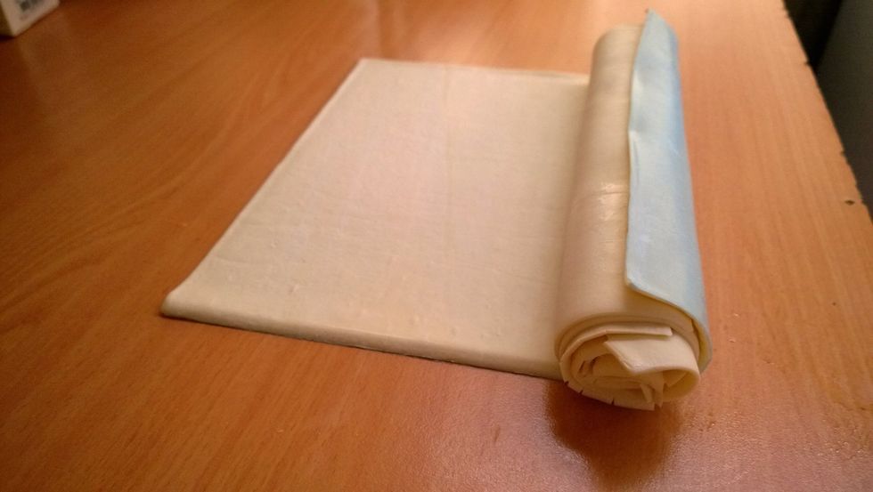 3rd layer of a pastry all wrapped up. Please do take off the plastic as you're rolling. I can't imagine the taste of burnt plastic egg tarts.