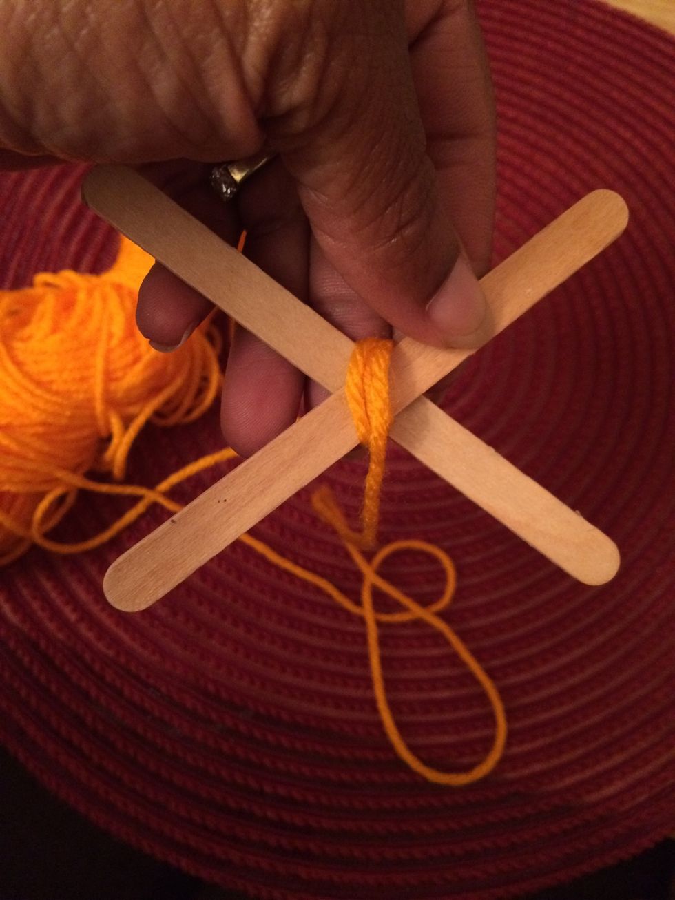 4. First wrap the yarn around the sticks going in this direction.